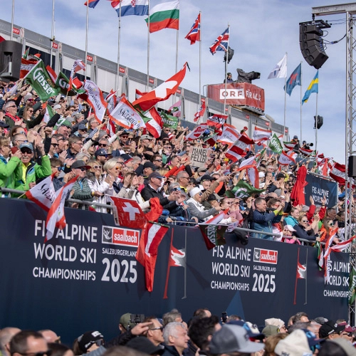 Spectators waving flags and banners at Audi FIS Ski World Cup Finale 2024.